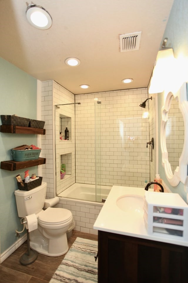 7501 N County Rd 29, Big Spring, TX 79720 - full bathroom with tiled shower / bath combo, vanity, recessed lighting, and wood finished floors