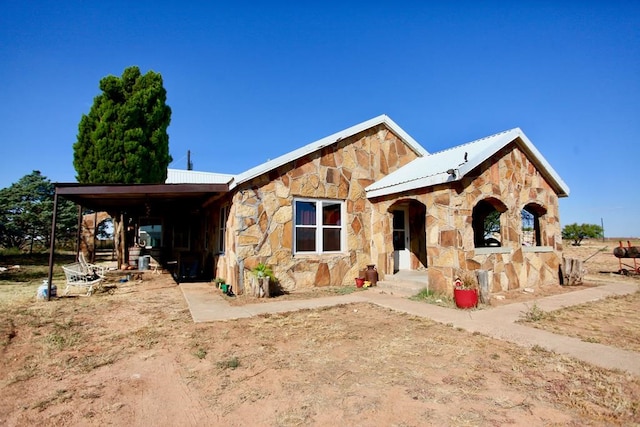 7501 N County Rd 29, Big Spring, TX 79720 - view of front facade featuring stone siding and a metal roof