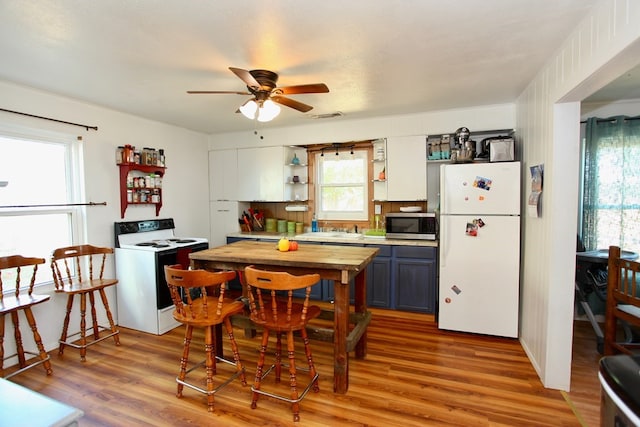7501 N County Rd 29, Big Spring, TX 79720 - kitchen with white appliances, a ceiling fan, light wood-style flooring, and open shelves