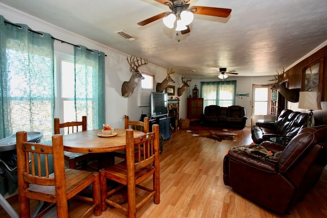 7501 N County Rd 29, Big Spring, TX 79720 - dining space featuring a ceiling fan, light wood-style flooring, healthy amount of natural light, and ornamental molding