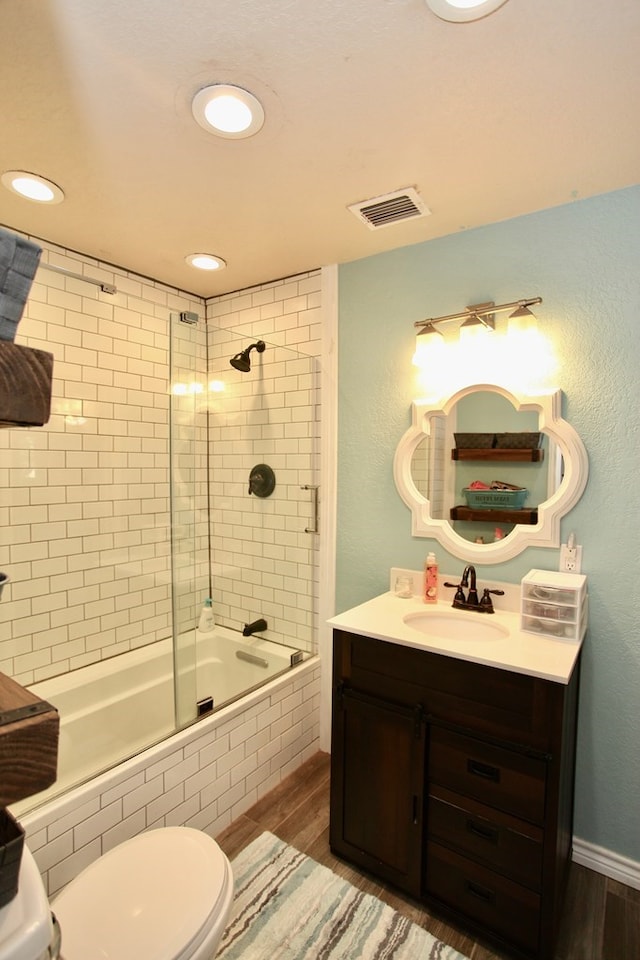 7501 N County Rd 29, Big Spring, TX 79720 - full bath featuring tiled shower / bath, vanity, recessed lighting, and wood finished floors