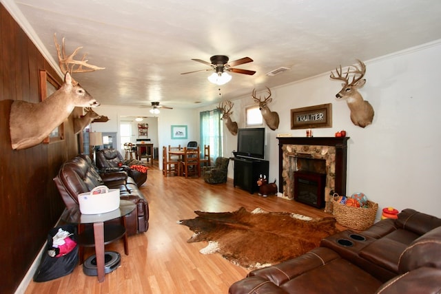 7501 N County Rd 29, Big Spring, TX 79720 - living room featuring a ceiling fan, wood finished floors, a fireplace, and crown molding