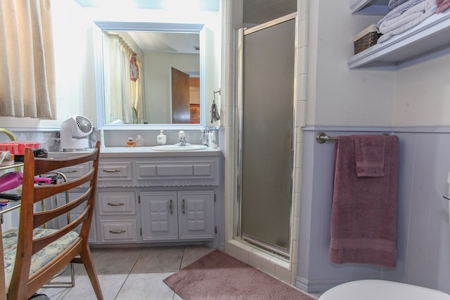 full bath featuring tile patterned floors, vanity, toilet, and a stall shower