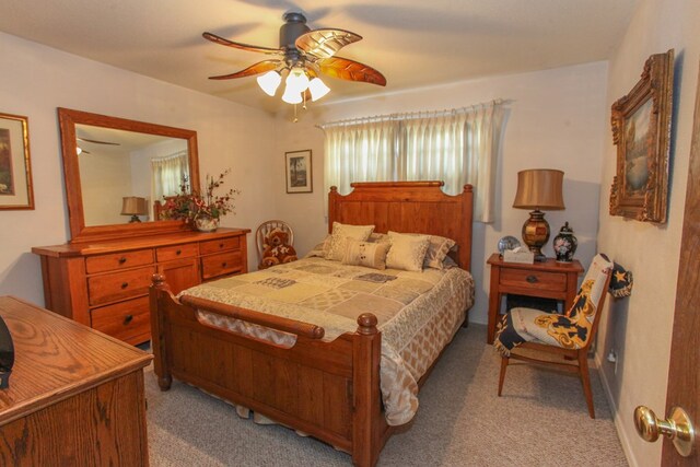 bedroom with light carpet and ceiling fan