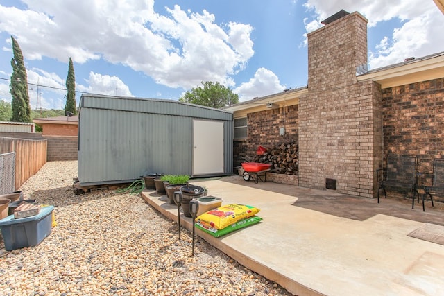 view of patio featuring an outdoor structure, a shed, and a fenced backyard