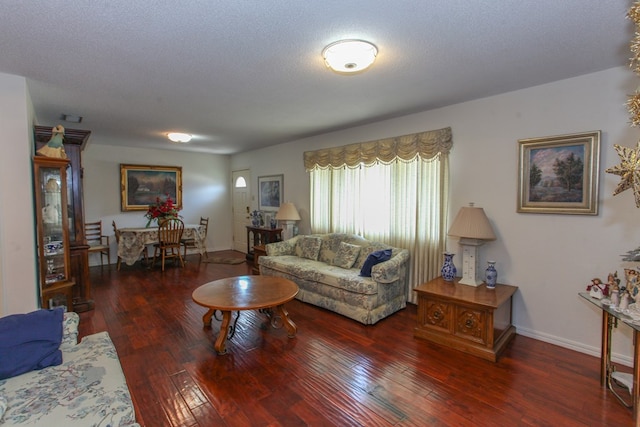 living area featuring baseboards and wood-type flooring