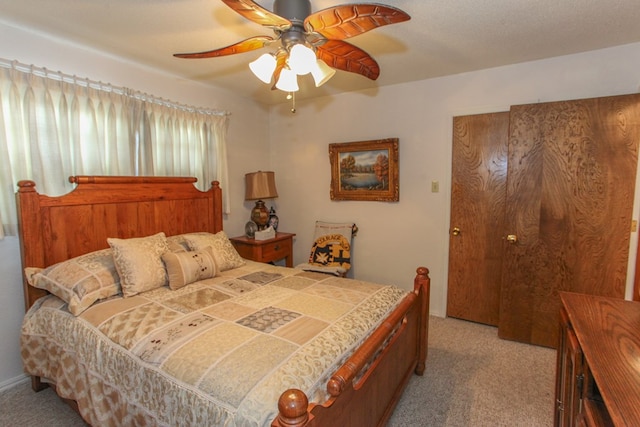 bedroom with a ceiling fan and carpet floors