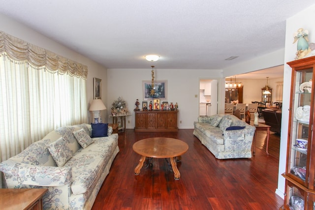 living area featuring an inviting chandelier and wood finished floors