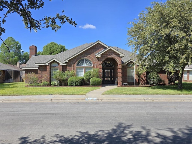 view of front of home featuring french doors and a front yard