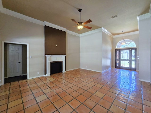 unfurnished living room with ceiling fan, crown molding, and tile patterned floors