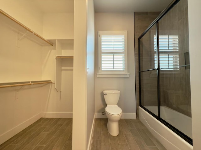 5516 E County Rd 93, Midland, TX 79706 - full bath with wood finish floors, enclosed tub / shower combo, and a spacious closet