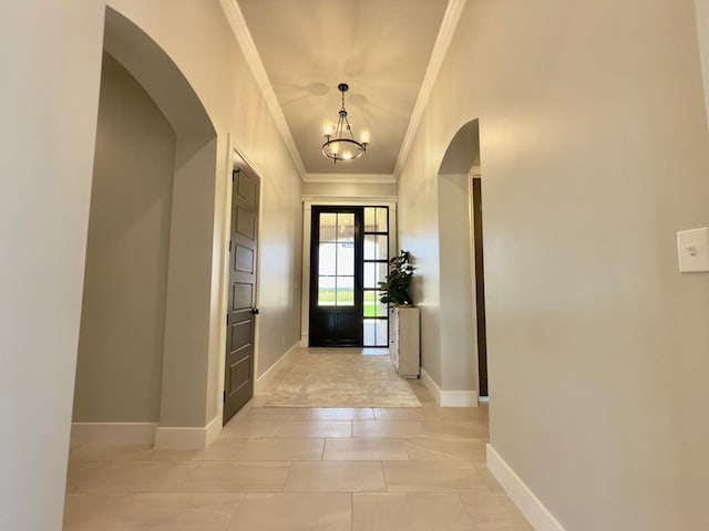 5516 E County Rd 93, Midland, TX 79706 - entrance foyer with crown molding, arched walkways, a chandelier, and light tile patterned floors