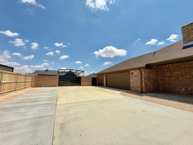 5516 E County Rd 93, Midland, TX 79706 - view of yard with driveway and a garage