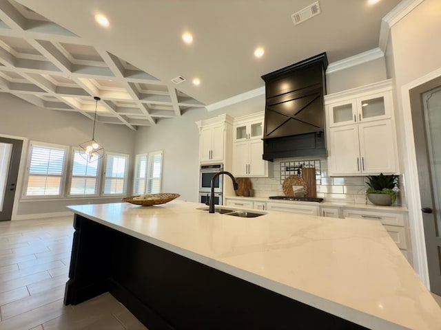 5516 E County Rd 93, Midland, TX 79706 - kitchen with gas stovetop, backsplash, coffered ceiling, white cabinets, and beamed ceiling
