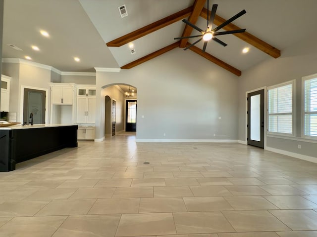 5516 E County Rd 93, Midland, TX 79706 - unfurnished living room featuring arched walkways, high vaulted ceiling, a ceiling fan, beamed ceiling, and recessed lighting