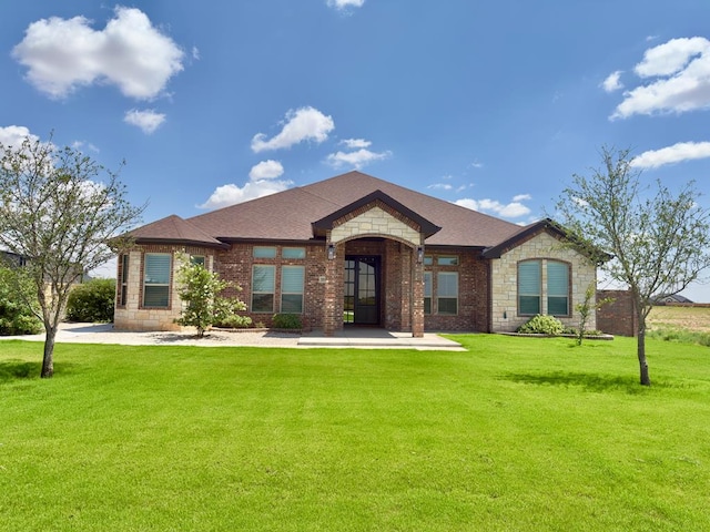 5516 E County Rd 93, Midland, TX 79706 - french country inspired facade with a front yard, brick siding, and stone siding