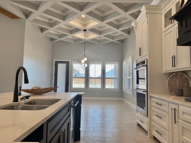 5516 E County Rd 93, Midland, TX 79706 - kitchen with beamed ceiling, coffered ceiling, white cabinetry, ventilation hood, and double oven
