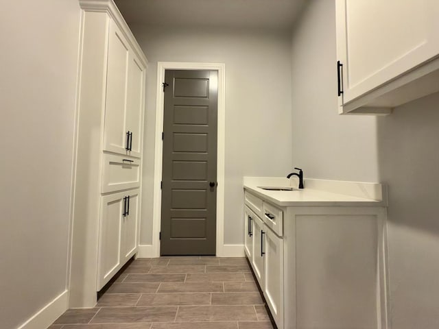 5516 E County Rd 93, Midland, TX 79706 - washroom with a sink and wood finish floors