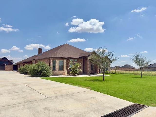 5516 E County Rd 93, Midland, TX 79706 - view of front of property with brick siding and a chimney