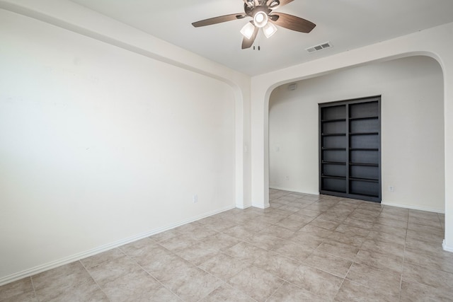4906 Meadowside St, Midland, TX 79705 - spare room with arched walkways, built in features, a ceiling fan, and light tile patterned flooring