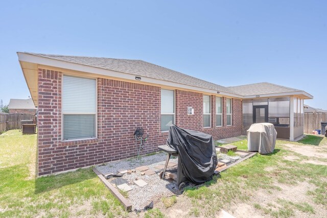 4906 Meadowside St, Midland, TX 79705 - back of house with a sunroom and brick siding
