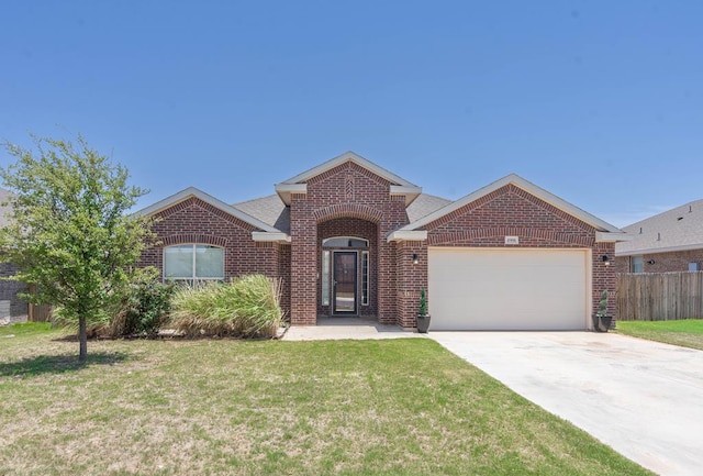 4906 Meadowside St, Midland, TX 79705 - view of front of home with brick siding, a garage, and driveway