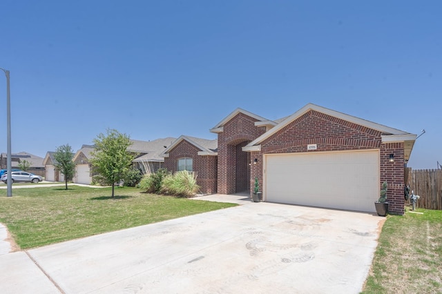 4906 Meadowside St, Midland, TX 79705 - ranch-style home with brick siding, concrete driveway, and a garage