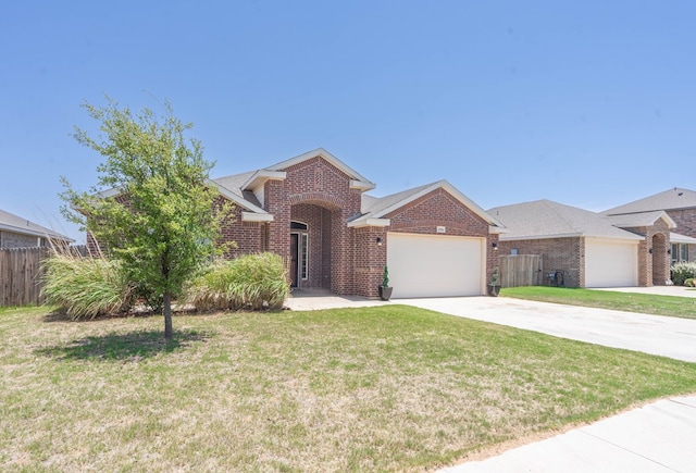 4906 Meadowside St, Midland, TX 79705 - view of front of property featuring brick siding, an attached garage, and driveway