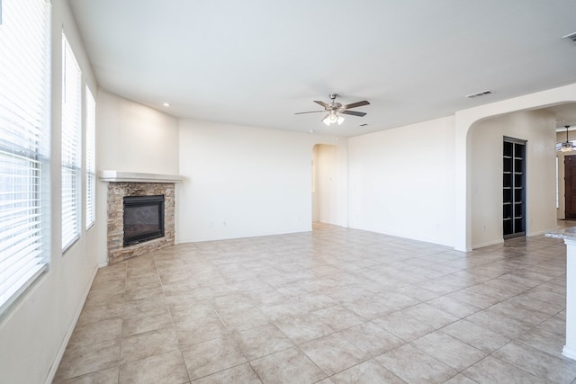 4906 Meadowside St, Midland, TX 79705 - unfurnished living room featuring arched walkways, a ceiling fan, a fireplace, and recessed lighting