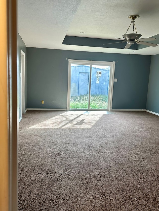 spare room with ceiling fan, carpet floors, and a textured ceiling