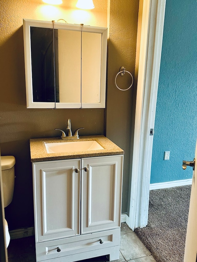 bathroom with tile patterned floors, vanity, and toilet