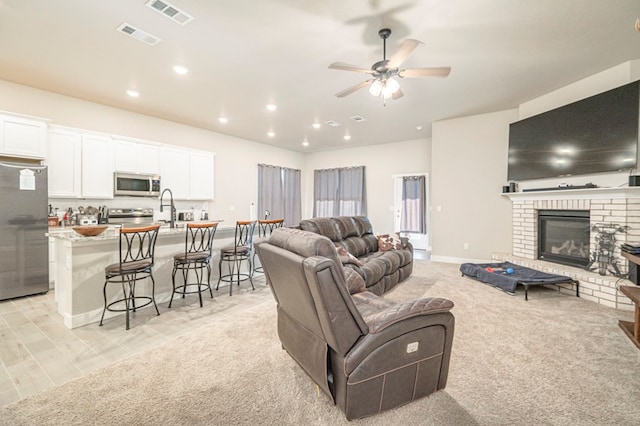 6909 Moonlight, Midland, TX 79705 - living area with ceiling fan, recessed lighting, a fireplace, and visible vents
