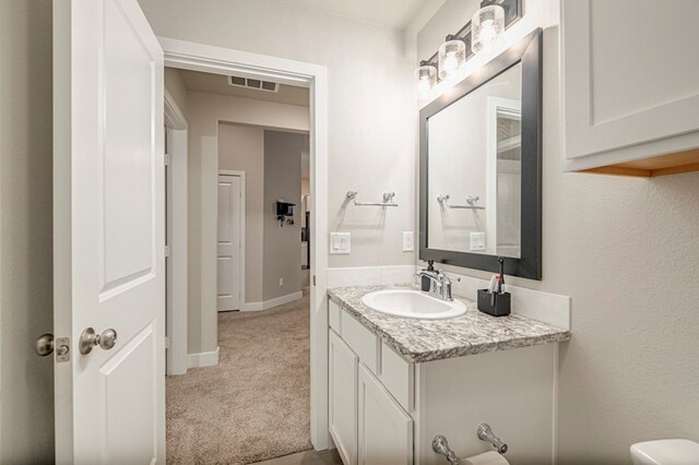 6909 Moonlight, Midland, TX 79705 - bathroom featuring vanity, baseboards, and visible vents