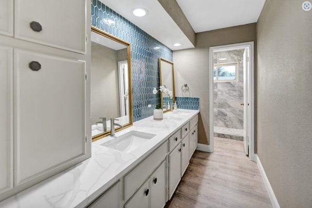 2 Auburn Ct, Midland, TX 79705 - full bathroom with baseboards, double vanity, a sink, and wood finished floors