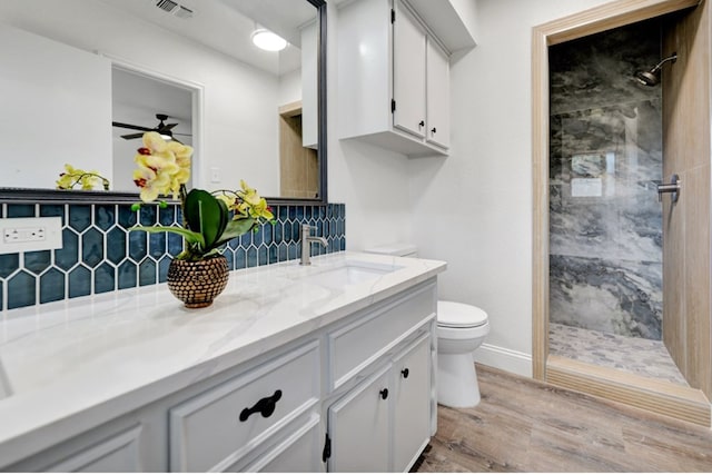 2 Auburn Ct, Midland, TX 79705 - full bath with toilet, visible vents, wood finished floors, and a tile shower