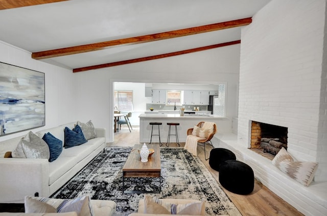 2 Auburn Ct, Midland, TX 79705 - living room with a brick fireplace, vaulted ceiling with beams, and wood finished floors