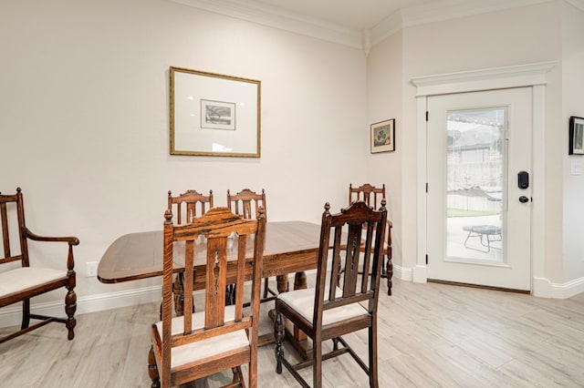 4506 San Pedro Ct, Midland, TX 79707 - dining space featuring baseboards, ornamental molding, and light wood-style flooring