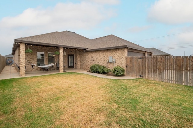 4506 San Pedro Ct, Midland, TX 79707 - rear view of property with brick siding, a fenced backyard, roof with shingles, and a yard