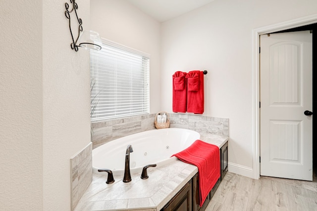 4506 San Pedro Ct, Midland, TX 79707 - full bath with a jetted tub, baseboards, and wood finished floors