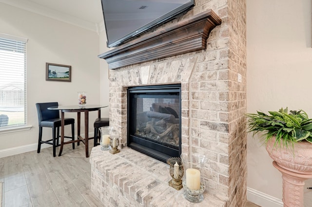 4506 San Pedro Ct, Midland, TX 79707 - room details with a brick fireplace, baseboards, ornamental molding, and wood finished floors