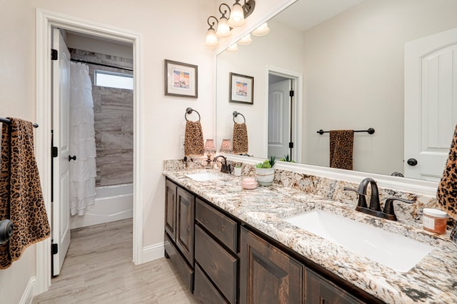 4506 San Pedro Ct, Midland, TX 79707 - full bath with a sink, baseboards, double vanity, and wood finished floors