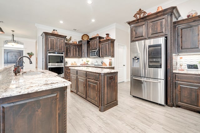 4506 San Pedro Ct, Midland, TX 79707 - kitchen with decorative backsplash, crown molding, appliances with stainless steel finishes, a center island, and a sink