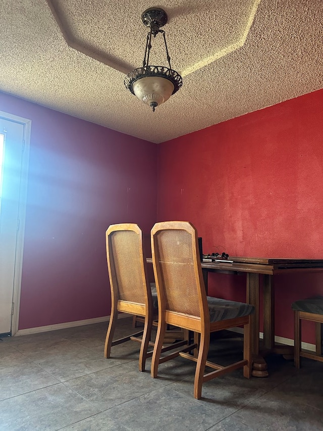 dining space featuring a textured ceiling