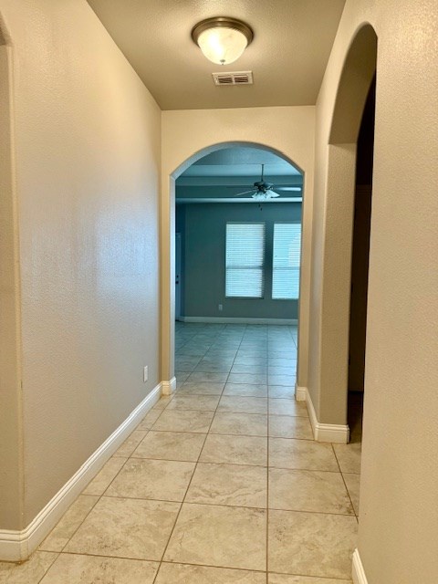 37 Devon Ct, Odessa, TX 79765 - hall with arched walkways and light tile patterned floors