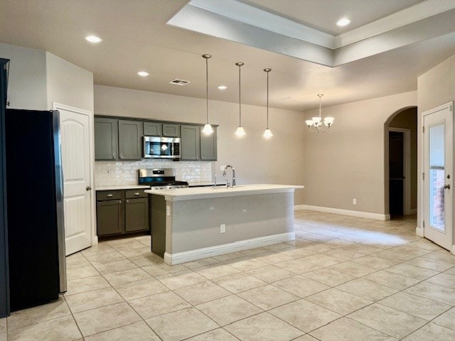 37 Devon Ct, Odessa, TX 79765 - kitchen with appliances with stainless steel finishes, light tile patterned flooring, arched walkways, backsplash, and gray cabinets