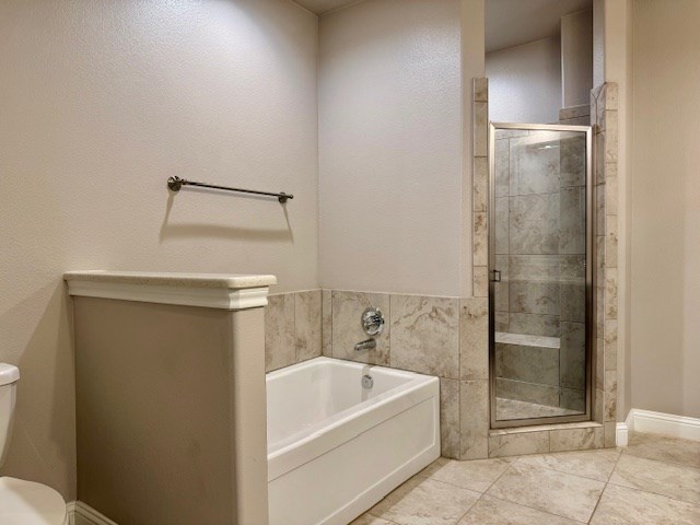 37 Devon Ct, Odessa, TX 79765 - bathroom with a garden tub, a stall shower, and tile patterned floors