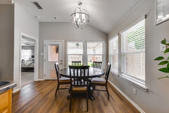 1328 E Dormard Ave, Midland, TX 79705 - dining room featuring a textured wall, dark wood finished floors, a chandelier, lofted ceiling, and baseboards