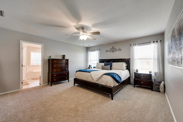 1328 E Dormard Ave, Midland, TX 79705 - bedroom featuring carpet, a textured ceiling, connected bathroom, a ceiling fan, and baseboards