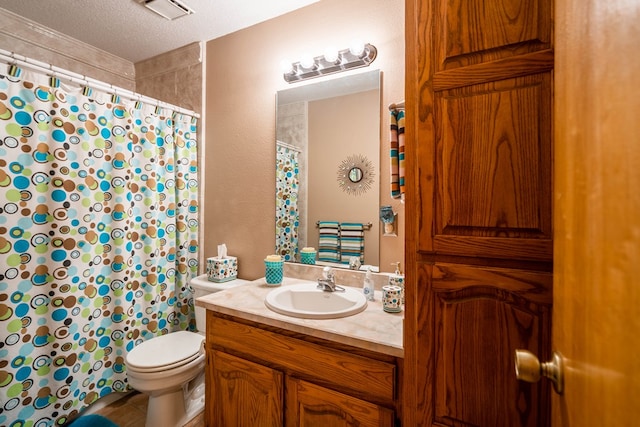 bathroom with toilet, curtained shower, vanity, visible vents, and a textured ceiling