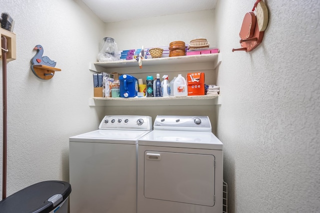 clothes washing area featuring laundry area and washer and clothes dryer